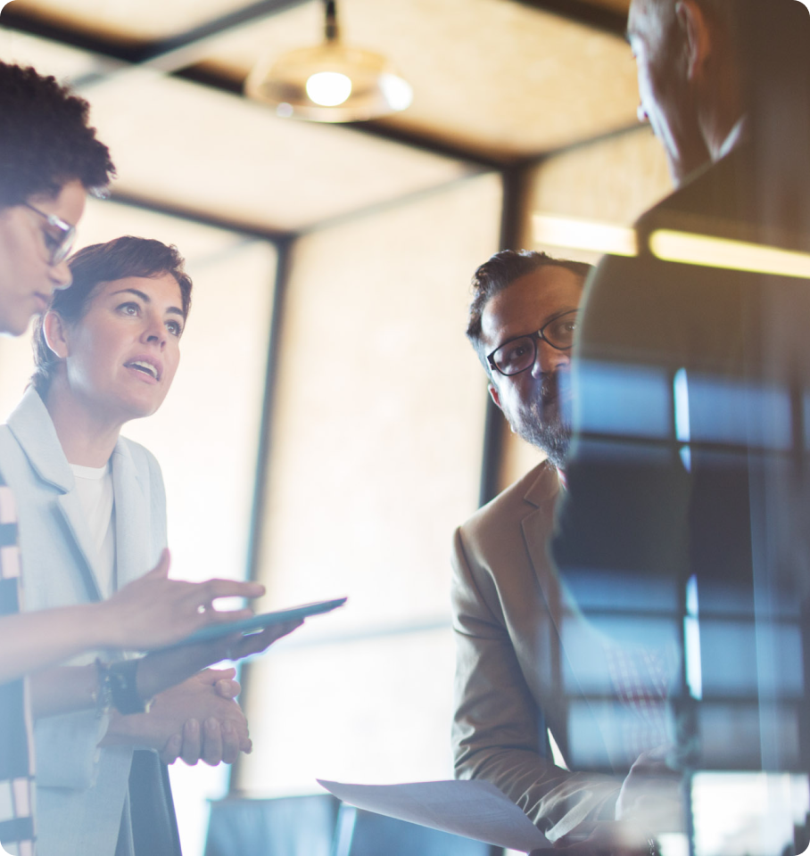 Image showing four HealthEdge professionals discussing customer success.