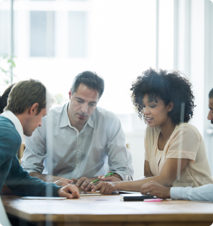 Image of a diverse group of colleagues collaborating around an office table.