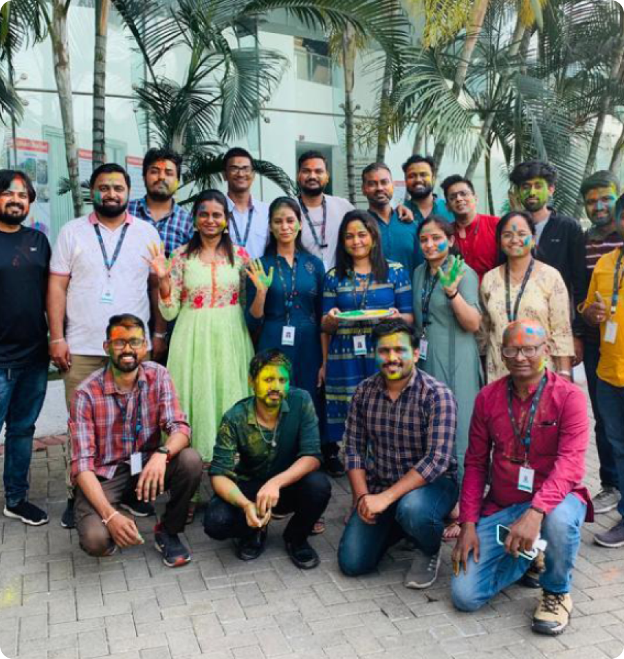 Image of HealthEdge professionals smiling in front of a modern office space in India