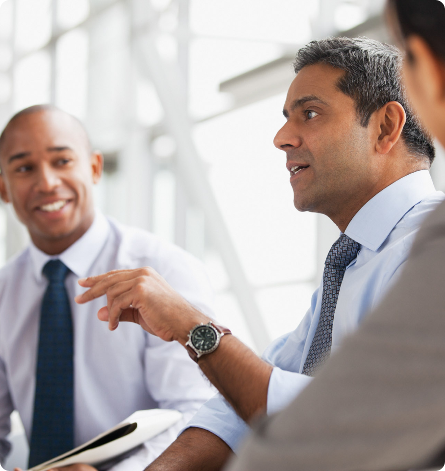 Image shows a group of diverse healthcare professionals having a discussion about HealthEdge’s® health plan with home and host capabilities.